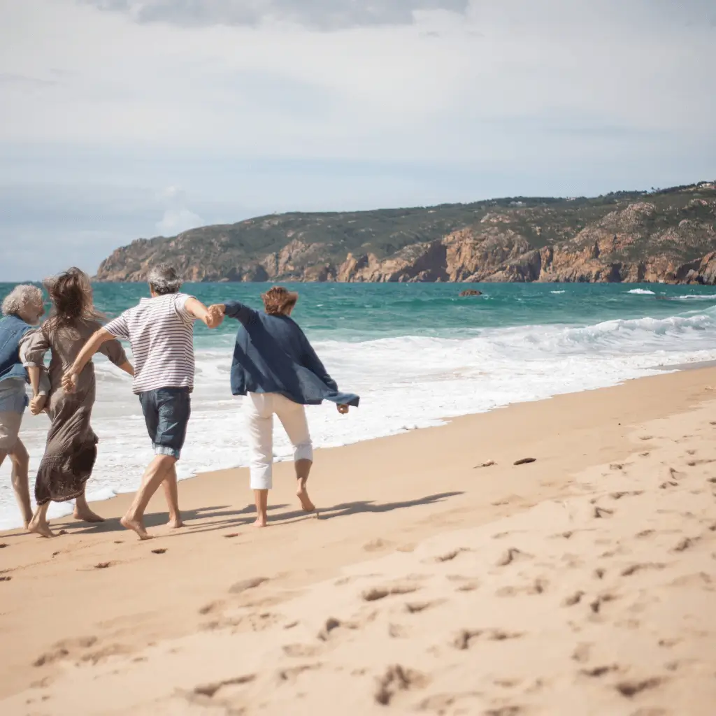 Older couples walking along the beach.