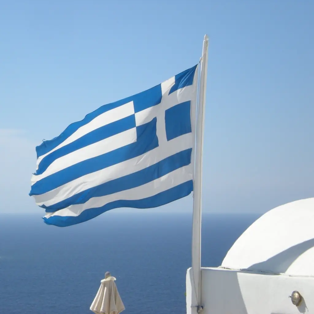 The flag of Greece flying in the sky.