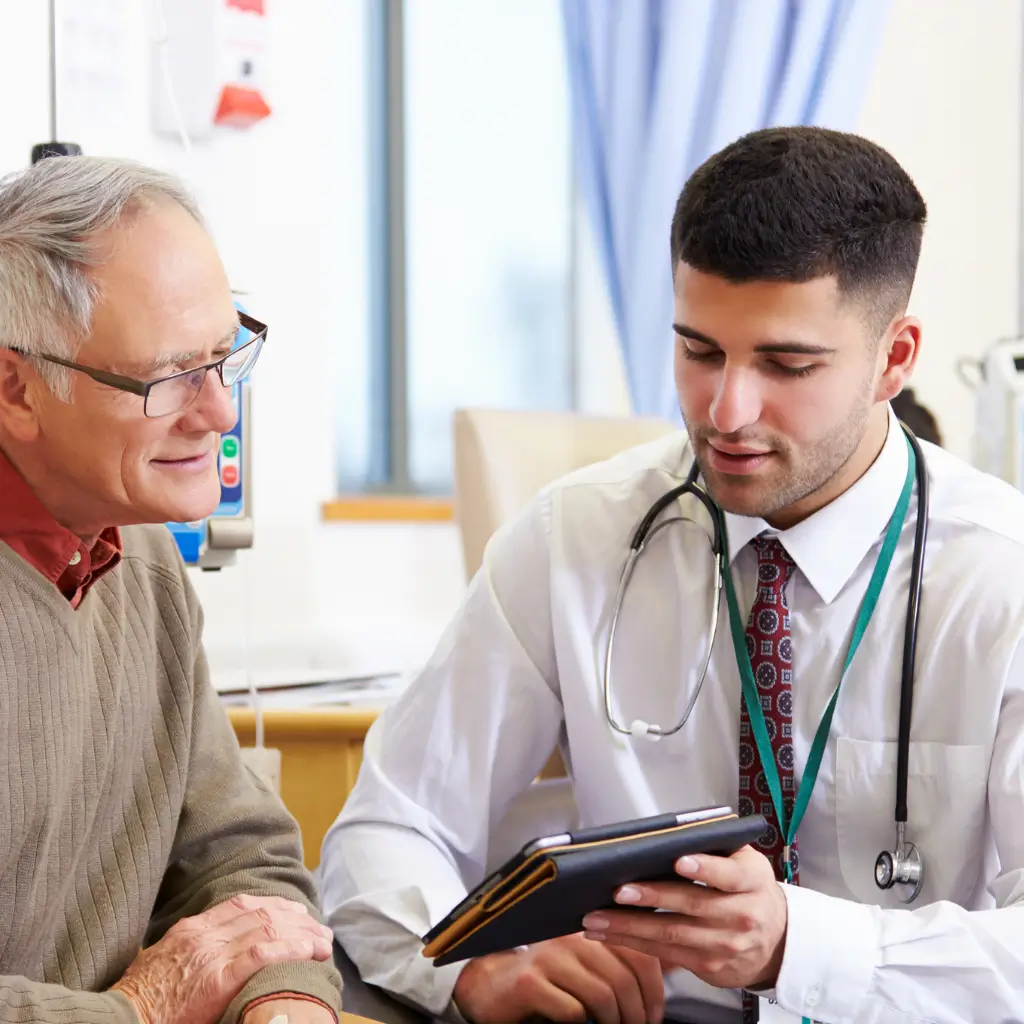 Old man getting a visa medical certificate in-person from a private UK medical doctor
