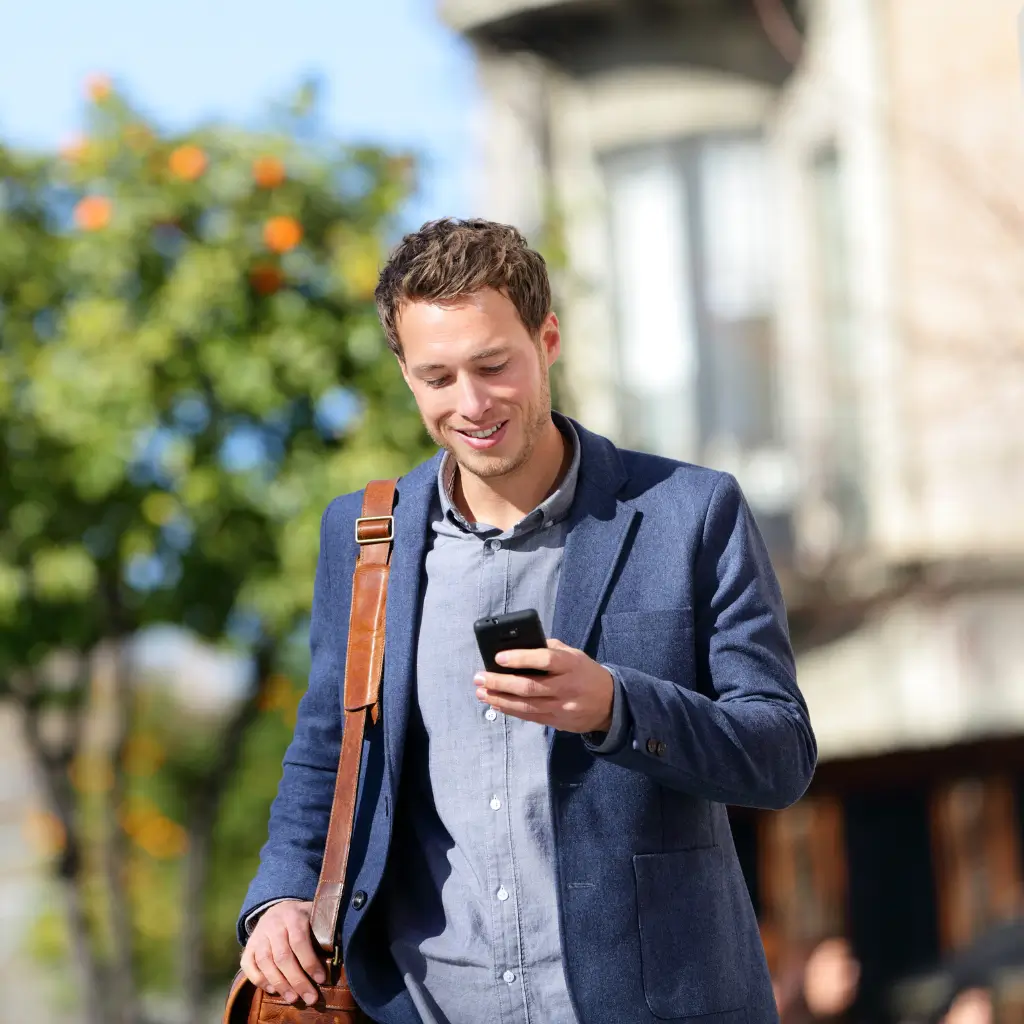 A man looking happy tracking the progress of his Spanish visa medical certificate issued by Wilmer Health, including the spanish translation and the apostille legalisation process